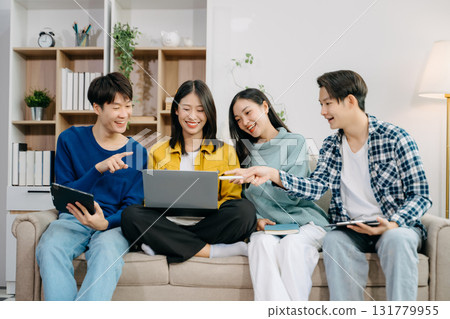Group of young Asian college students working on his project assignment, using laptop computer and tablet an online informations. together, enjoy talking Group of young Asian college students working on his project assignment, using laptop computer and tablet an online informations. together, enjoy talking 131779955