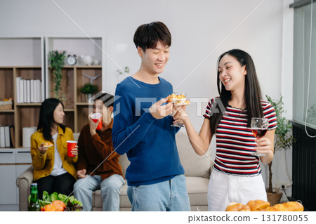 Group of Young Asian friend having, enjoy evening party together at home. Attractive young man and woman having fun, eating food, celebrate at home 131780055