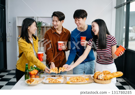 Group of Young Asian friend having, enjoy evening party together at home. Attractive young man and woman having fun, eating food, celebrate at home Group of Young Asian friend having, enjoy evening party together at home. Attractive young man and woman having fun, eating food, celebrate at home 131780285