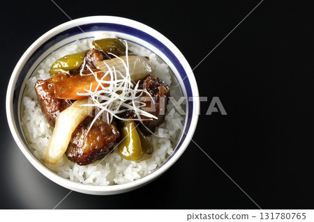 Sweet and sour pork bowl with black vinegar photographed against a black background Sweet and sour pork bowl with black vinegar photographed against a black background 131780765