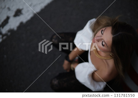 Woman posing on the road wearing fashionable clothes 131781550