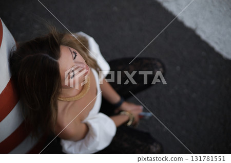 Woman posing on the road wearing fashionable clothes Woman posing on the road wearing fashionable clothes 131781551