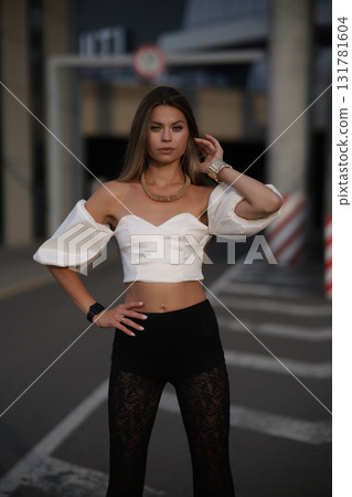 Woman posing on the road wearing fashionable clothes Woman posing on the road wearing fashionable clothes 131781604