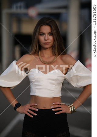 Woman posing on the road wearing fashionable clothes 131781609