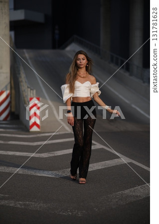 Woman posing on the road wearing fashionable clothes 131781628