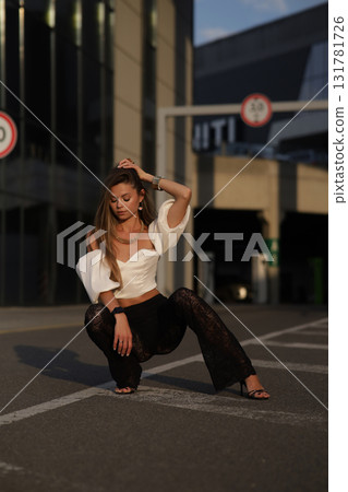 Woman posing on the road wearing fashionable clothes Woman posing on the road wearing fashionable clothes 131781726