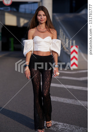 Woman posing on the road wearing fashionable clothes 131781777