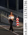 Woman posing on the road wearing fashionable clothes 131781786