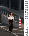 Woman posing on the road wearing fashionable clothes 131781812