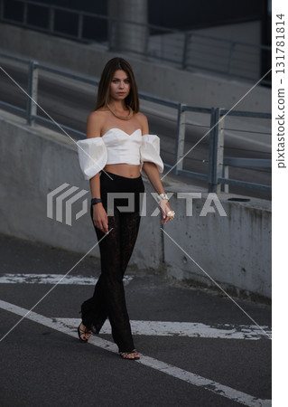 Woman posing on the road wearing fashionable clothes 131781814