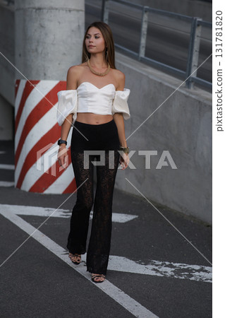 Woman posing on the road wearing fashionable clothes 131781820