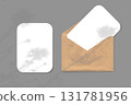 The shadow of wildflowers falls on an envelope with two sheets of textured white paper on a gray background. Mockup horizontal orientation. 131781956
