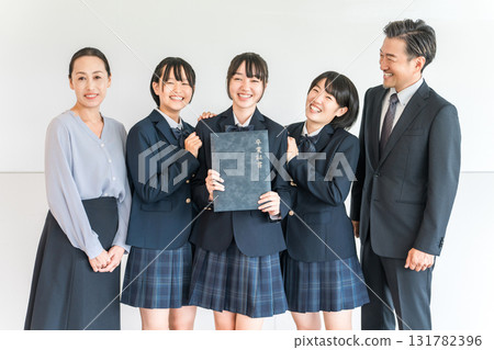 Uniforms and blazers holding graduation certificates, elementary school and junior high school girls and male and female teachers 131782396