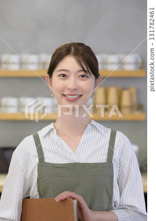 A female cafe clerk giving directions A female cafe clerk giving directions 131782461