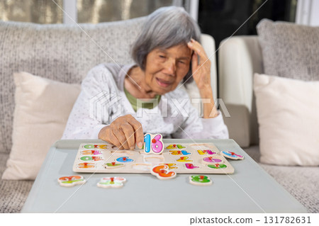 Asian Senior Woman With Dementia is Confuse a Number Puzzle Game. 131782631