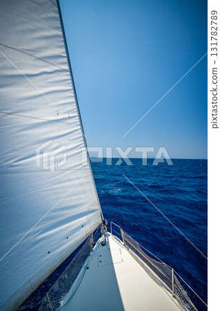 View from the mast down to the bow of a sailing yacht moving under full sails near Croatia. Freedom, adventure, yachting lifestyle and dynamic sea travel. View from the mast down to the bow of a sailing yacht moving under full sails near Croatia. Freedom, adventure, yachting lifestyle and dynamic sea travel. 131782789