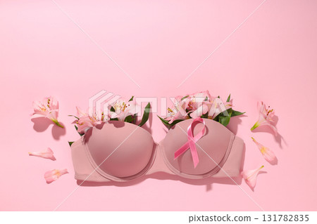 Pink bra surrounded by flowers and a pink ribbon 131782835