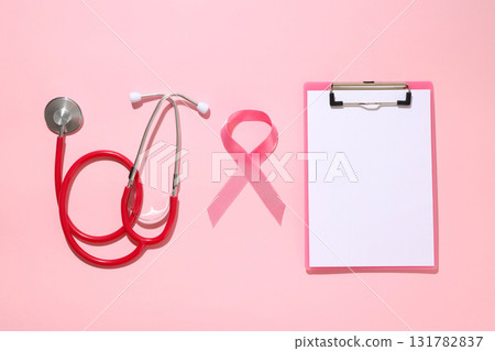Medical stethoscope and pink ribbon on a light background 131782837