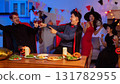Dinner and group of people celebrating together at Halloween party. 131782955
