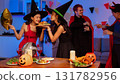 Dinner and group of people celebrating together at Halloween party. 131782956