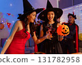 Dinner and group of people celebrating together at Halloween party. 131782958