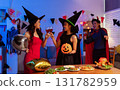 Dinner and group of people celebrating together at Halloween party. 131782959