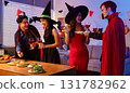 Dinner and group of people celebrating together at Halloween party. 131782962