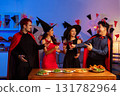 Dinner and group of people celebrating together at Halloween party. 131782964