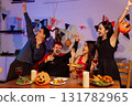 Dinner and group of people celebrating together at Halloween party. 131782965