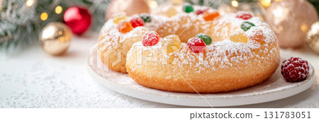 Three kings holiday festive fruitcake topped with colorful candied fruits on a table, background 131783051