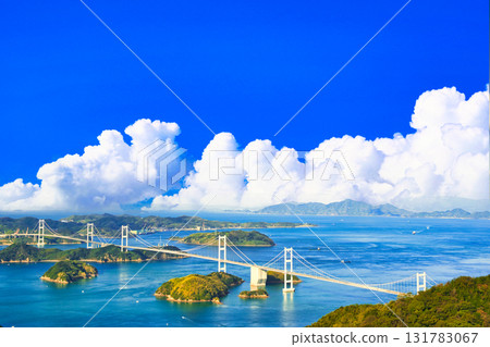A beautiful bridge on the Shimanami Kaido and a cumulonimbus cloud composite 131783067
