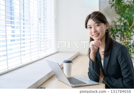 Woman sitting and looking at camera 131784038
