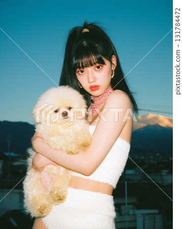 Woman holding a poodle 131784472