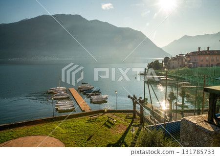 nICE VIEW ONcoastline of  lAKE Como: :boats moored by pier in oparking lots 131785733