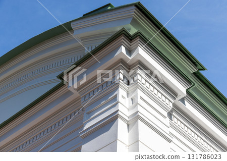 Close-up of a classical building corner featuring white decorative molding 131786023