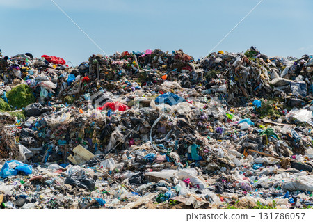 Large heaps of mixed waste cover a landfill, showcasing the severe pollution and ecological impact of garbage disposal practices on the environment Large heaps of mixed waste cover a landfill, showcasing the severe pollution and ecological impact of garbage disposal practices on the environment 131786057