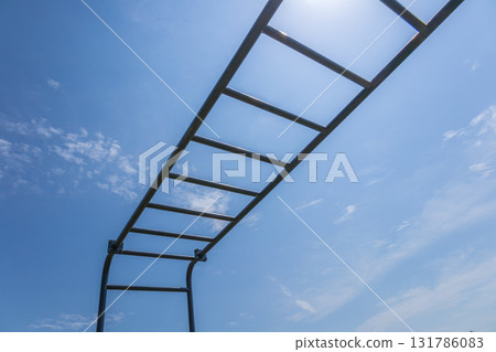Fitness enthusiasts can use these horizontal training bars in the park to improve strength and perform various exercises under clear skies Fitness enthusiasts can use these horizontal training bars in the park to improve strength and perform various exercises under clear skies 131786083