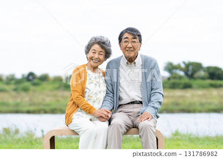Senior couple relaxing in the park Senior couple relaxing in the park 131786982