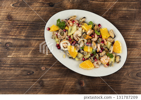 Plate of delicious fruit salad with seafood. Plate of delicious fruit salad with seafood. 131787209