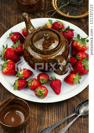 Strawberry tea with fresh strawberries. 131787225