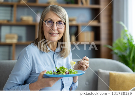 A professional sitting at a desk working with a laptop and writing notes, conveying concentration and productivity in a bright office environment. A professional sitting at a desk working with a laptop and writing notes, conveying concentration and productivity in a bright office environment. 131788189