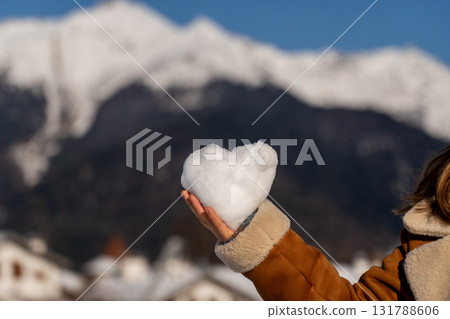 Snow Heart Mountains Winter: Romantic snow heart held outdoors, snowy mountain backdrop, winter season. Snow Heart Mountains Winter: Romantic snow heart held outdoors, snowy mountain backdrop, winter season. 131788606