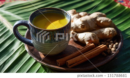 South Asian Wellness Tea Ritual with Turmeric, Cinnamon, and Ginger on Banana Leaf South Asian Wellness Tea Ritual with Turmeric, Cinnamon, and Ginger on Banana Leaf 131788681