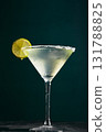 Glass of martini with cocktail or mocktail and lime wedge on dark background 131788825