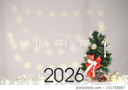 Festive Decor. Mini Christmas tree and 2026 for holiday spirit. 131788867