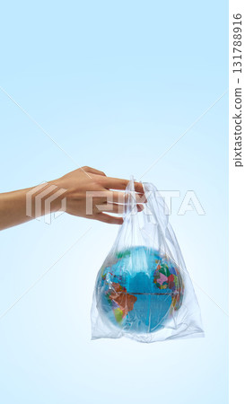 Hand holding planet Earth in plastic bag symbolizing pollution and fragility 131788916