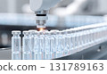Pharmaceutical production line at factory showing robot automation. robotic arm seals glass vaccine vial, precise part of medical drug manufacturing process 131789163