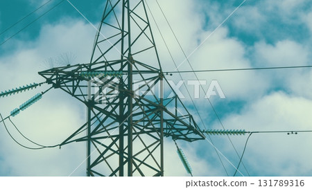 An Electricity Transmission Tower Stands Tall Against a Dramatic Cloudy Sky Backdrop An Electricity Transmission Tower Stands Tall Against a Dramatic Cloudy Sky Backdrop 131789316