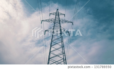 High Voltage Power Lines Towering Majestically Against a Dramatic and Beautiful Sky Above High Voltage Power Lines Towering Majestically Against a Dramatic and Beautiful Sky Above 131789350