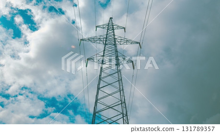 High Voltage Power Line Stretching Across The Dramatic Sky With Clouds And Sunlight High Voltage Power Line Stretching Across The Dramatic Sky With Clouds And Sunlight 131789357